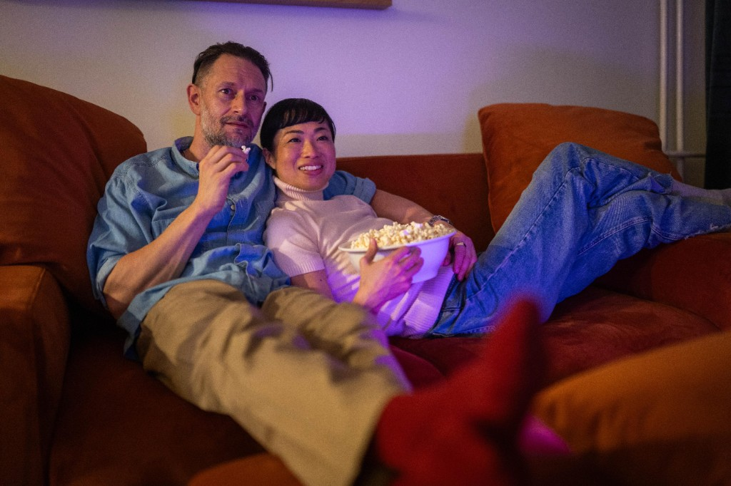 Couple watching a movie with popcorn